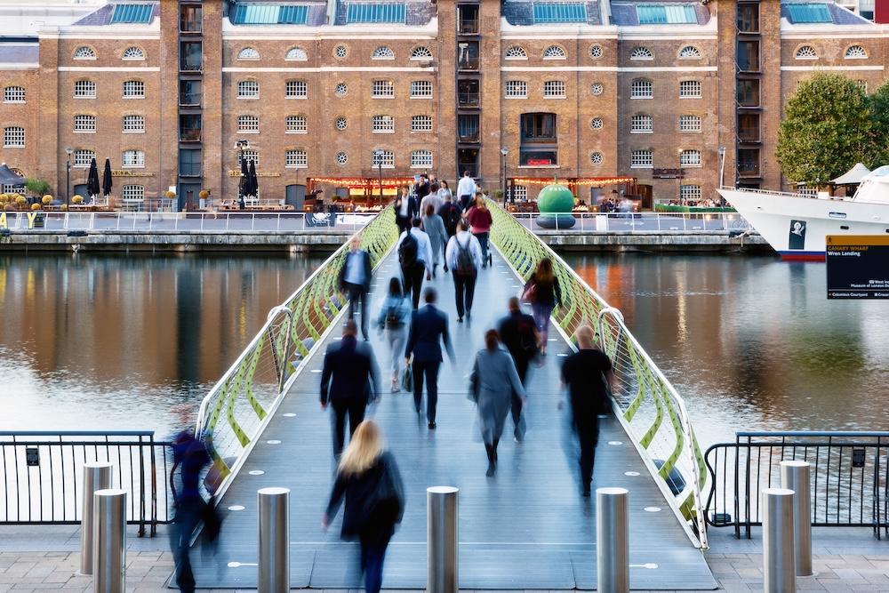 North Dock Footbridge from Canary Wharf to West India Quay in London with unidentified crossing people
